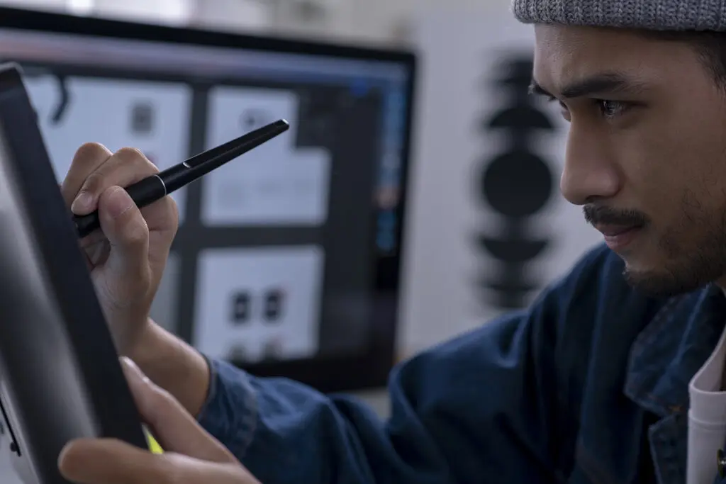 Designer working on a project using a drawing tablet for digital art